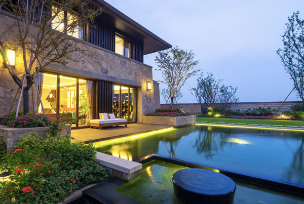Blog - Insurance Marketplace Realities 2022 – Personal lines - Modern Home Glowing at Sun Down With An In Ground Pool
